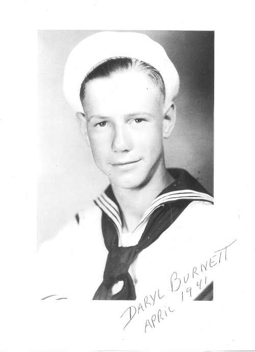 A photo of a young man in a sailor's uniform with the text "Daryl Burnett, April 1941" written on it.